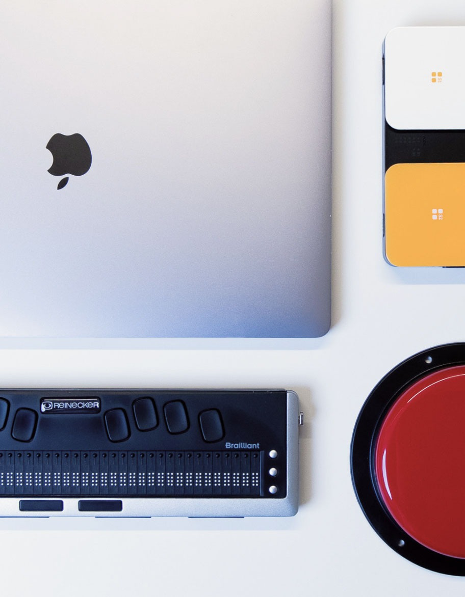 A set of accessibility testing devices on the desk next to each other.